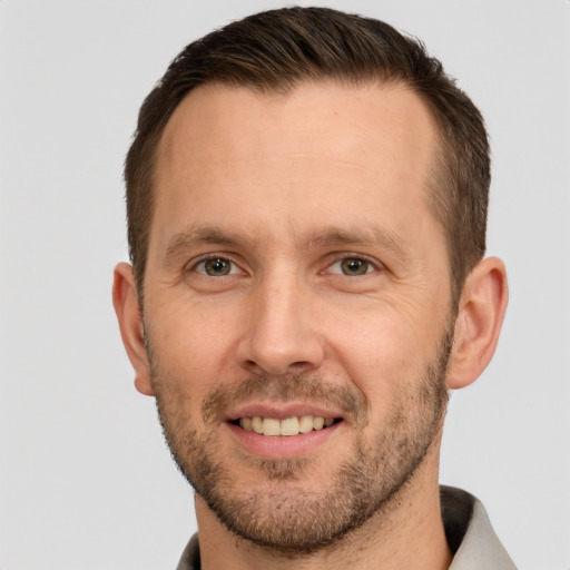 Joyful white adult male with short  brown hair and brown eyes