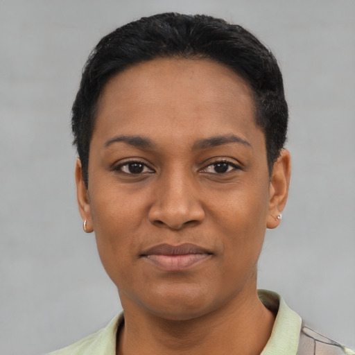 Joyful latino young-adult female with short  black hair and brown eyes