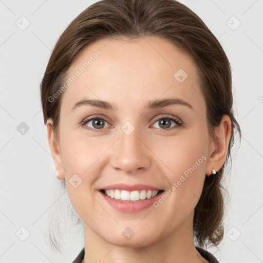 Joyful white young-adult female with medium  brown hair and grey eyes