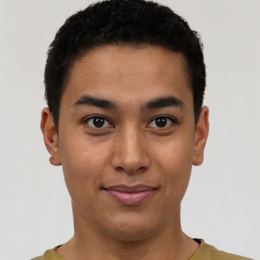 Joyful latino young-adult male with short  brown hair and brown eyes