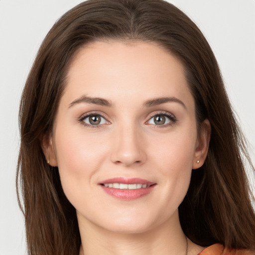 Joyful white young-adult female with long  brown hair and grey eyes