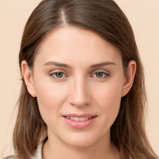 Joyful white young-adult female with long  brown hair and grey eyes