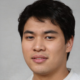 Joyful asian young-adult male with short  black hair and brown eyes