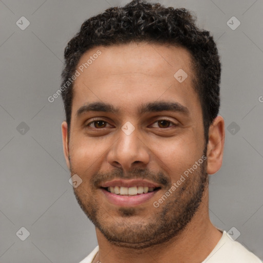 Joyful white young-adult male with short  black hair and brown eyes