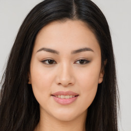 Joyful asian young-adult female with long  brown hair and brown eyes