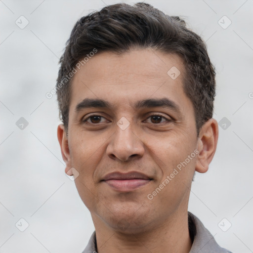 Joyful white adult male with short  brown hair and brown eyes