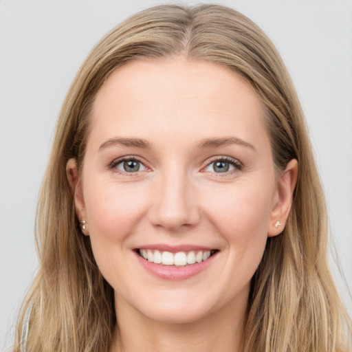 Joyful white young-adult female with long  brown hair and blue eyes