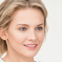 Joyful white young-adult female with long  brown hair and blue eyes