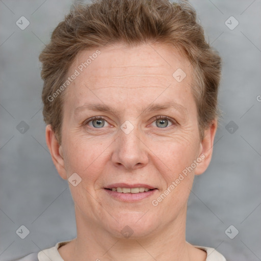 Joyful white adult female with short  brown hair and grey eyes