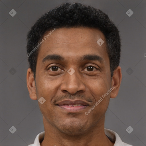 Joyful black adult male with short  brown hair and brown eyes