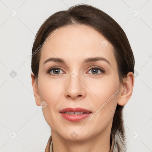 Joyful white young-adult female with long  brown hair and grey eyes