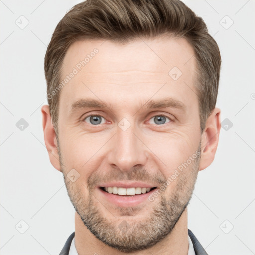 Joyful white young-adult male with short  brown hair and grey eyes