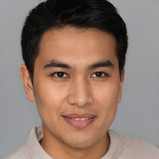 Joyful asian young-adult male with short  brown hair and brown eyes
