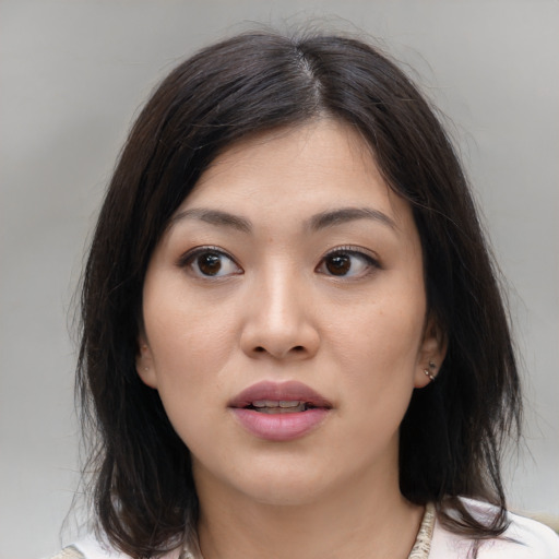 Joyful asian young-adult female with medium  brown hair and brown eyes