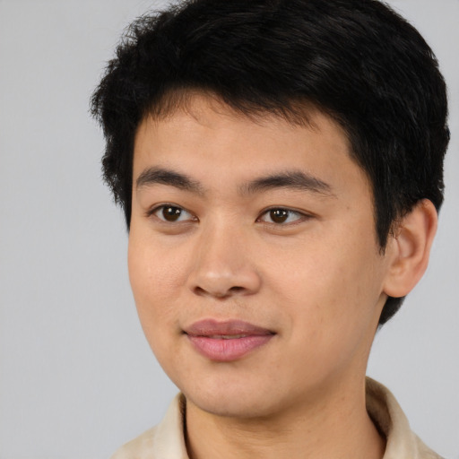 Joyful asian young-adult male with short  brown hair and brown eyes