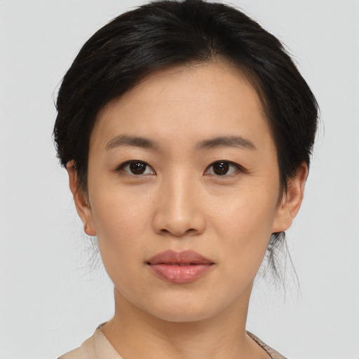 Joyful asian young-adult female with medium  black hair and brown eyes