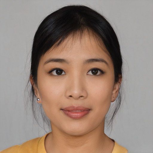 Joyful asian young-adult female with medium  black hair and brown eyes