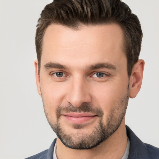 Joyful white young-adult male with short  brown hair and brown eyes