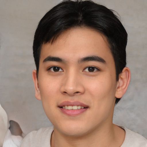 Joyful asian young-adult male with short  black hair and brown eyes