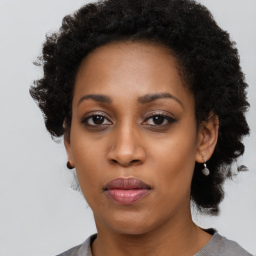 Neutral black young-adult female with medium  black hair and brown eyes