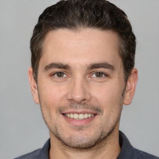 Joyful white young-adult male with short  brown hair and brown eyes