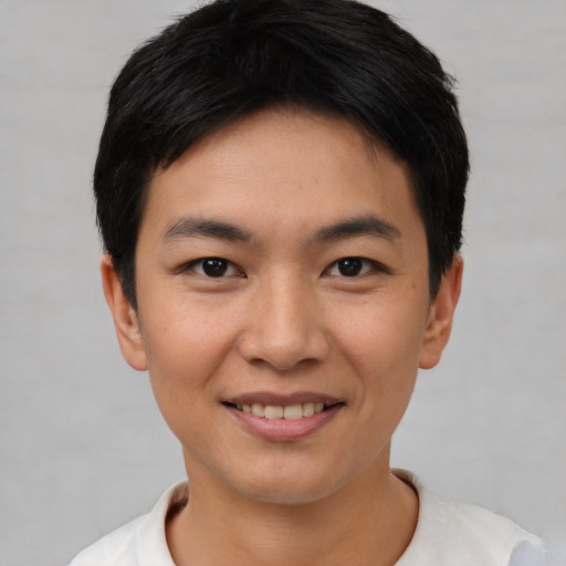 Joyful asian young-adult male with short  black hair and brown eyes