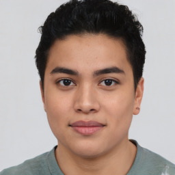 Joyful latino young-adult male with short  black hair and brown eyes