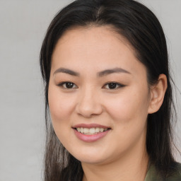 Joyful asian young-adult female with long  brown hair and brown eyes