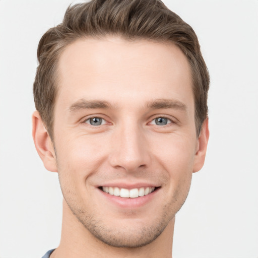 Joyful white young-adult male with short  brown hair and grey eyes