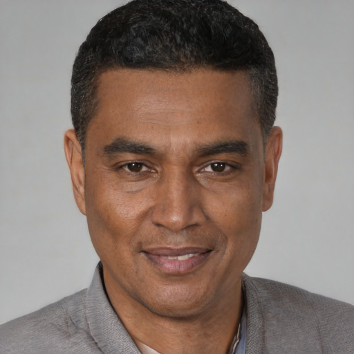 Joyful latino adult male with short  black hair and brown eyes