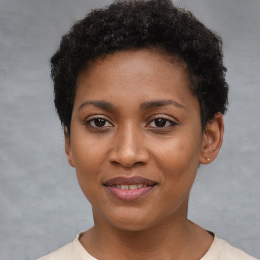 Joyful black young-adult female with short  brown hair and brown eyes