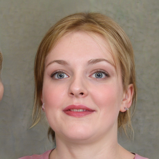 Joyful white young-adult female with medium  brown hair and blue eyes