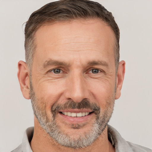 Joyful white adult male with short  brown hair and brown eyes