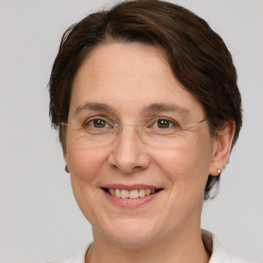 Joyful white adult female with medium  brown hair and grey eyes