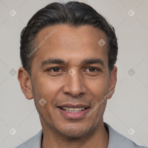 Joyful latino adult male with short  black hair and brown eyes