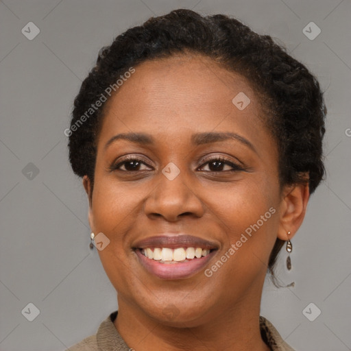 Joyful black young-adult female with short  brown hair and brown eyes