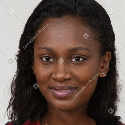 Joyful black young-adult female with long  brown hair and brown eyes