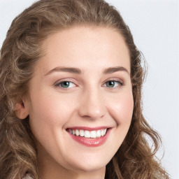 Joyful white young-adult female with long  brown hair and green eyes