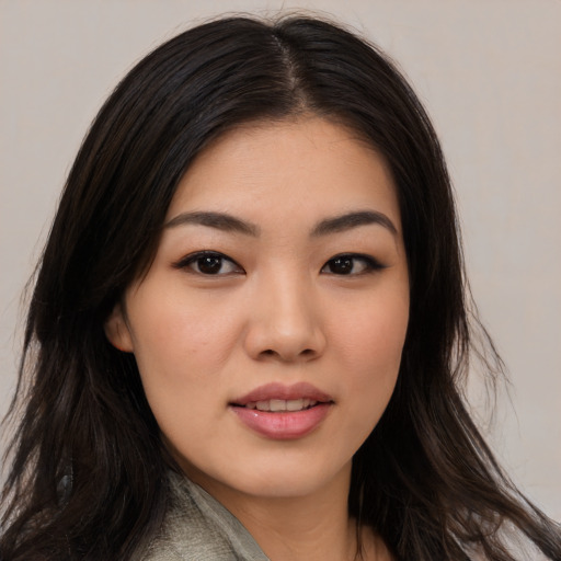 Joyful asian young-adult female with long  black hair and brown eyes