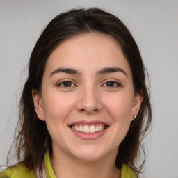 Joyful white young-adult female with medium  brown hair and brown eyes