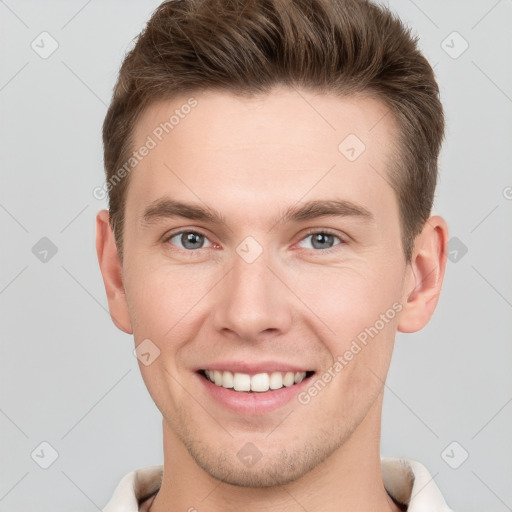 Joyful white young-adult male with short  brown hair and grey eyes