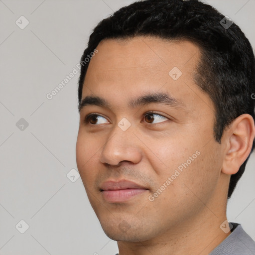 Joyful white young-adult male with short  black hair and brown eyes