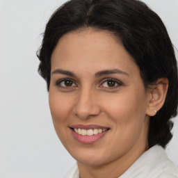 Joyful latino young-adult female with medium  brown hair and brown eyes