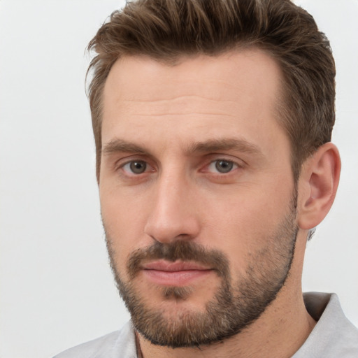 Joyful white adult male with short  brown hair and brown eyes