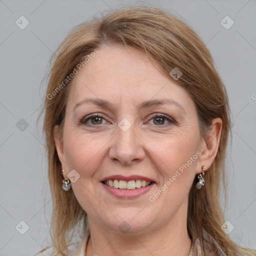 Joyful white adult female with long  brown hair and grey eyes