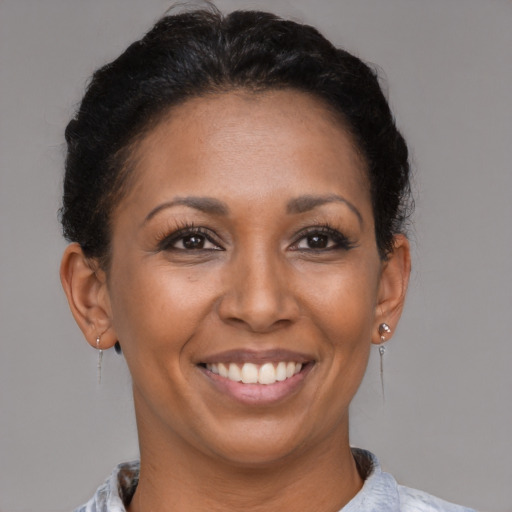 Joyful black adult female with short  brown hair and brown eyes