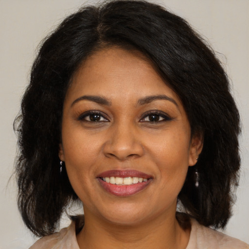 Joyful black young-adult female with medium  brown hair and brown eyes