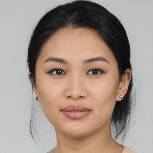 Joyful asian young-adult female with medium  black hair and brown eyes