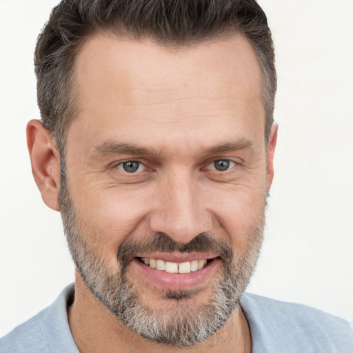 Joyful white adult male with short  brown hair and brown eyes