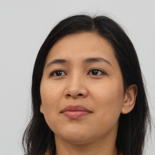 Joyful asian young-adult female with long  brown hair and brown eyes